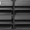 A close-up, grayscale image of a storage system with multiple shelves and compartments. Produktbild-Vorschau