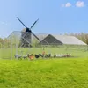 A large chicken coop with a windmill in the background. Produktbild-Vorschau