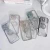 Several clear phone cases with diamond embellishments are arranged on a light-colored surface. Produktbild-Vorschau