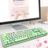 A close-up shot of a green wireless keyboard and mouse set on a white desk, with a computer monitor in the background. Náhled obrázku produktu