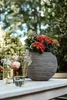A table setting with flowers and a planter outdoors. Náhľad obrázku produktu