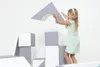 A young girl is building with large foam blocks. Produktbild-Vorschau