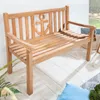 A wooden garden bench with an anchor design on a light-colored wooden floor.