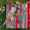A couple is relaxing on a picnic blanket in a grassy area. Podgląd zdjęcia produktu