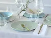 A table setting with plates, bowls, glasses, and cutlery. Náhľad obrázku produktu