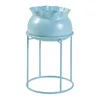 A light blue plant stand with a matching pot, shown against a white background. Produktbild-Vorschau