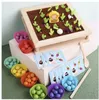 A wooden toy garden with colorful balls and cards, suggesting a game or educational toy. Voir les images du produit