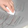 A hand is shown cleaning a gray surface with a white cloth. Produktbild-Vorschau