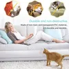 A woman is relaxing on a couch using a laptop while a cat is on the floor nearby. Produktbild-Vorschau