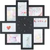 A black photo frame collage clock with multiple picture frames arranged around a central clock face. Produktbild-Vorschau