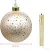 A lit glass ball ornament with star cutouts and a separate gold cylinder with a light string. Náhled obrázku produktu