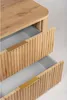 A close-up view of a wooden cabinet with two drawers, one partially open, revealing a grey interior. Both drawers have gold handles and a fluted wooden front. Voir les images du produit