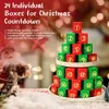 A Christmas advent calendar made of building blocks stacked in a tree shape, with a Santa Claus figure in the background. Produktbild-Vorschau