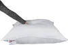 A hand is pressing down on a white pillow. Produktbild-Vorschau
