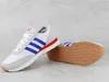 A pair of Adidas sneakers shown on a light gray background. Voir les images du produit