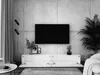 A modern living room with a TV stand and television against a concrete wall. Voir les images du produit