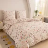 A neatly made bed with a floral and bunny patterned duvet cover and pillows. Náhľad obrázku produktu