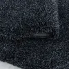 A close-up view of a dark gray shaggy rug, showing its texture and the underside. Produktbild-Vorschau