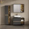 A modern bathroom vanity set with a tall cabinet, a sink vanity, and a medicine cabinet against a textured wall. Produktbild-Vorschau