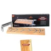 A product shot of a wooden salmon grilling board and its stainless steel holder, with packaging in the background. Produktbild-Vorschau