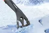 A black ice scraper with a red handle is shown scraping ice off a surface, with a snowy mountain landscape in the background. Anteprima dell’immagine prodotto