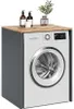 A white washing machine housed within a gray cabinet with a wooden top. Decorative items are placed on the wooden surface. Náhľad obrázku produktu