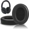 A pair of black replacement ear pads for headphones, with a pair of headphones in the background. Produktbild-Vorschau