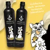 Two black bottles of Spitzmund Vanilleköm are shown with a cartoon cat character enjoying the drink. Produktbild-Vorschau