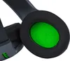 Close-up view of a black gaming headset ear cup with a bright green interior. Produktbild-Vorschau