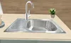 A stainless steel kitchen sink with a faucet and a small potted plant on a countertop. Náhled obrázku produktu