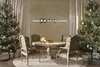 A dining room decorated for Christmas with two Christmas trees, a dining table, and chairs. Produktbild-Vorschau