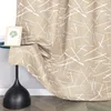 A close-up of a beige curtain with a white abstract pattern, draped over a black lamp. Produktbild-Vorschau