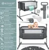 A baby bed with a teddy bear and a baby, surrounded by feature callouts. Produktbild-Vorschau