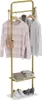 A gold coat rack with clothes and accessories on it. Produktbild-Vorschau