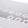 A close-up view of a white storage cart with a decorative cutout pattern. Náhled obrázku produktu