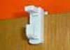 A close-up of a white curtain bracket against an orange and brown background. Produktbild-Vorschau