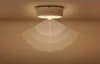A motion-activated night light mounted on a ceiling, with radiating lines indicating its detection range. Podgląd zdjęcia produktu