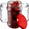 Three glass jars, one filled with cherries, with a red lid next to it. Anteprima dell’immagine prodotto