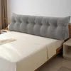 A large, tufted wedge pillow is placed on a bed. Produktbild-Vorschau
