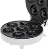 An open donut maker with multiple donut molds. Podgląd zdjęcia produktu