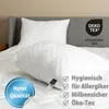 Two white pillows are placed on a bed with a gray headboard. The pillows have a quilted chevron pattern. There are several marketing overlays and logos on the image. Produktbild-Vorschau