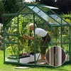 A woman tending to plants inside a greenhouse. Náhled obrázku produktu