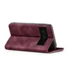 A burgundy flip case for a smartphone is shown from a side angle, with the case open to reveal the phone's camera module. Produktbild-Vorschau