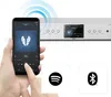 A hand holding a smartphone is shown in the foreground, with a hi-fi tuner in the background. The smartphone displays a music app, and the tuner has a screen showing song information. Two icons, Spotify and Bluetooth, are displayed below the smartphone. Anteprima dell’immagine prodotto