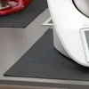 A close-up shot of a kitchen appliance on a counter, with a placemat underneath. Produktbild-Vorschau