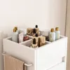A white cosmetics organizer filled with various bottles and tubes. Produktbild-Vorschau