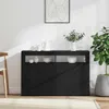 A black sideboard with open shelves, decorated with white ceramic items and a plant in a pot. Anteprima dell’immagine prodotto