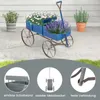A blue wooden wagon planter filled with flowers, displayed on a patio with other plants and a house in the background. The bottom of the image contains three close-up circular insets highlighting product features. Voir les images du produit