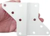 A hand holding a white metal bracket with multiple holes. Produktbild-Vorschau