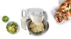 A kitchen mixer with dough in its bowl, a salad, and a loaf of bread are arranged on a white background. Produktbild-Vorschau